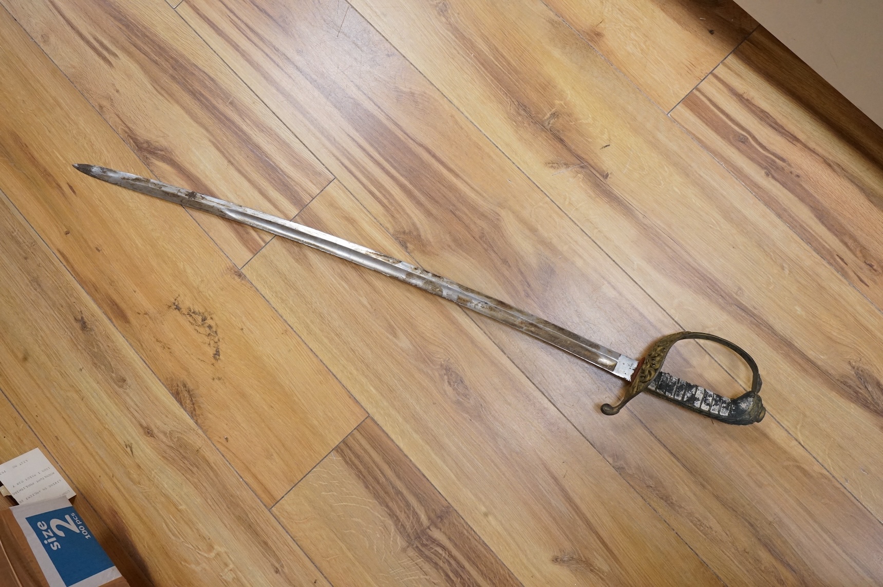 An officer’s sword, three walking sticks and an antique sword stick, longest walking stick 92cm long